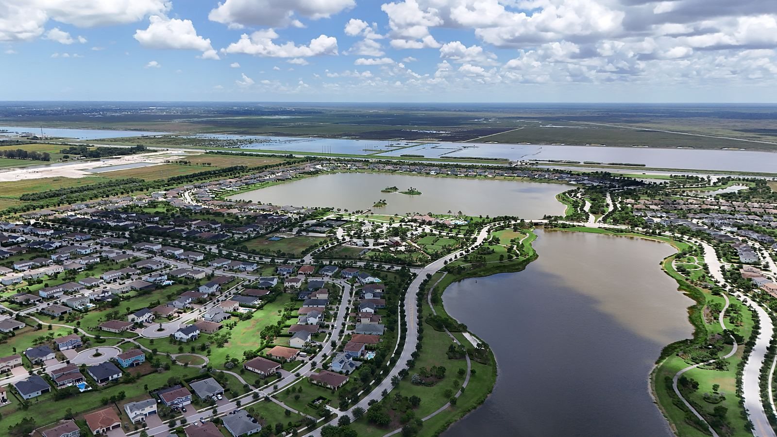 Drone aerial of two lakes and hundreds of finished homes at Arden