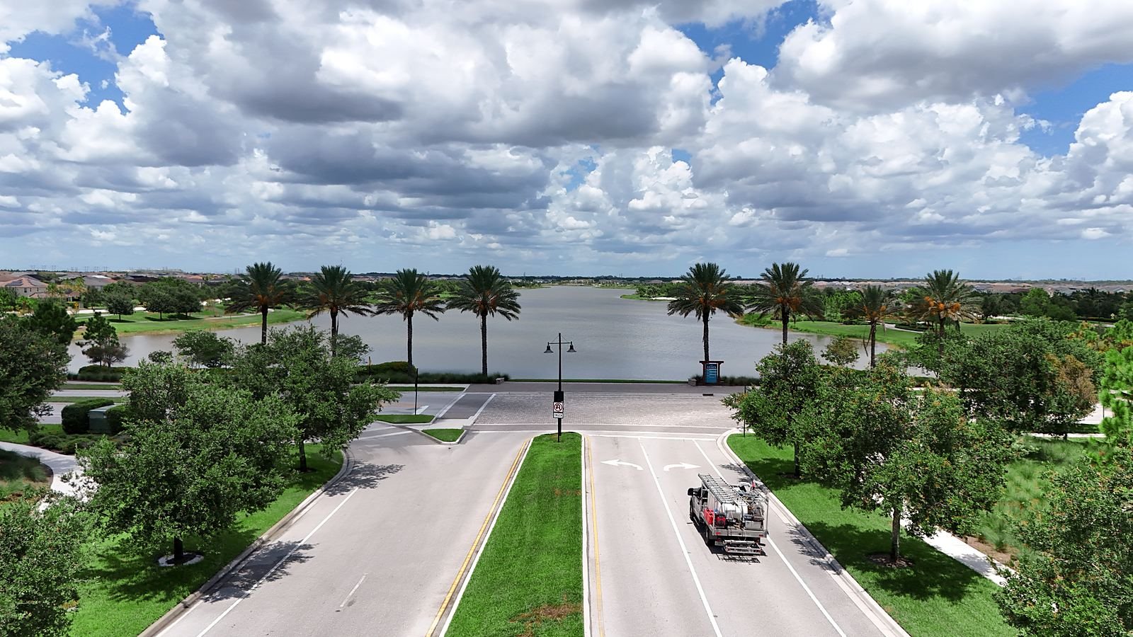 Palm-lined entrance boulevard leading to the lake at Arden